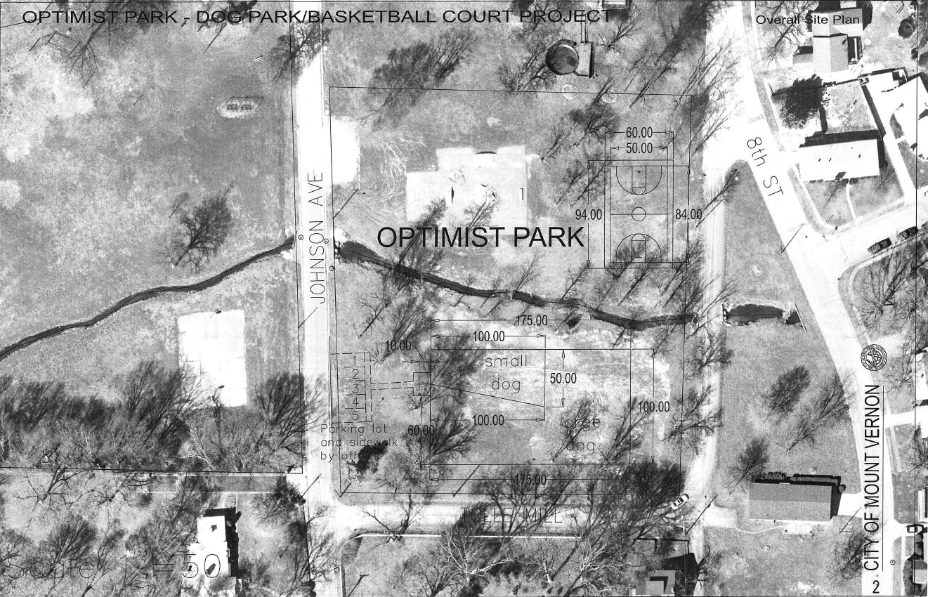 Black and white aerial showing roads, trees, park equipment