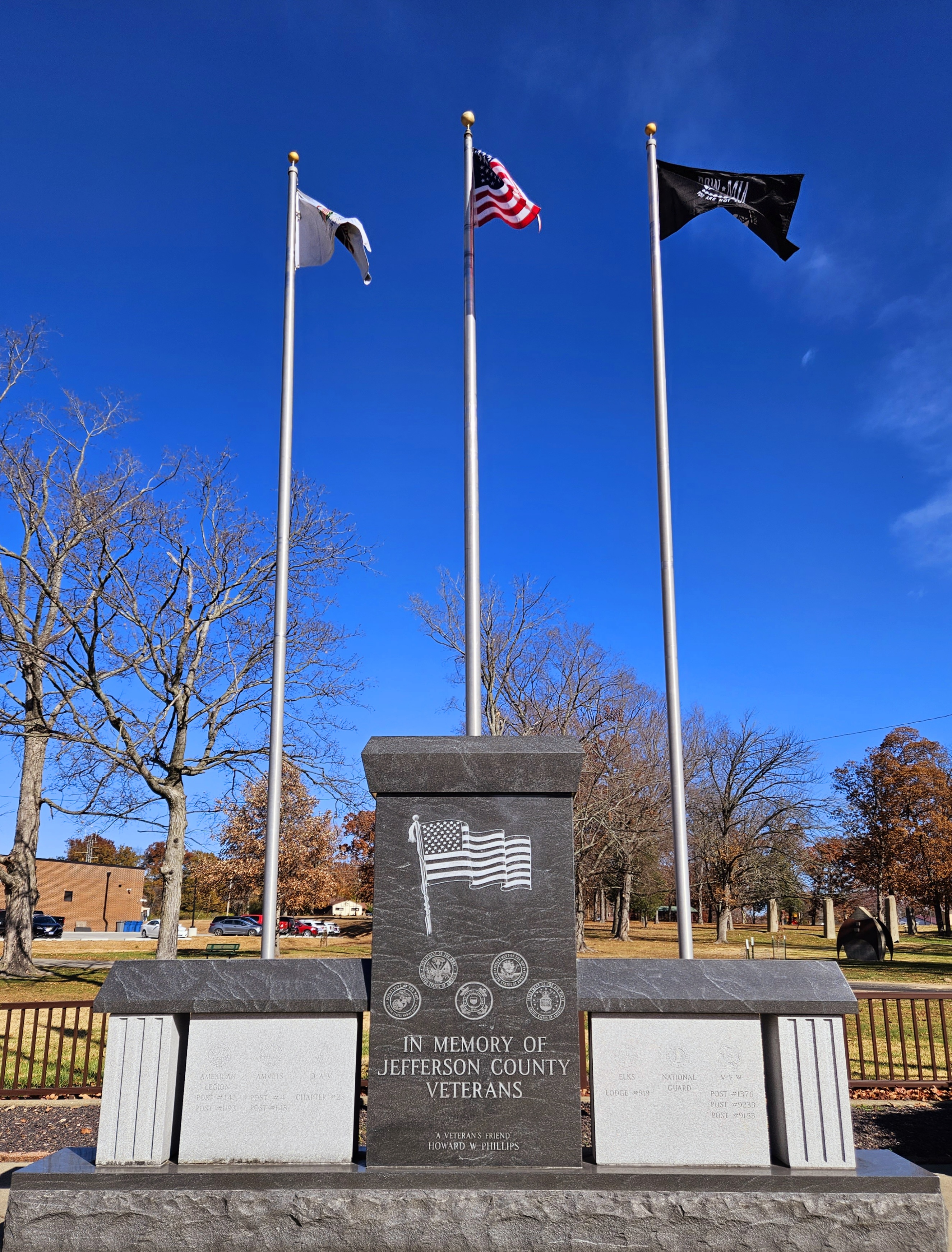 Veterans stone monument with flags